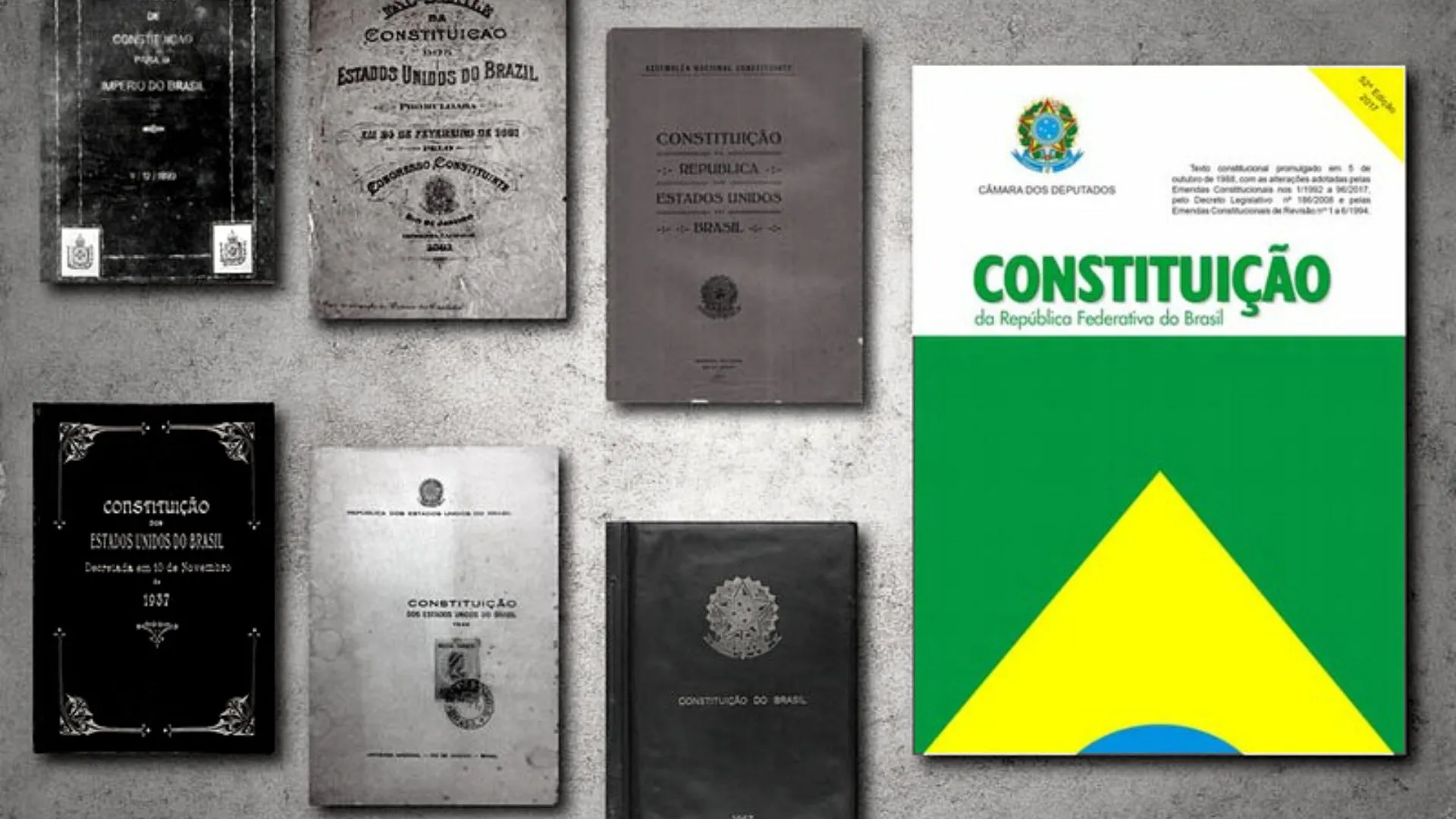 Imagem com duas fileiras de documentos, apresentando as sete Constituições do país, textos importantes para basear as reformas tributárias no Brasil.